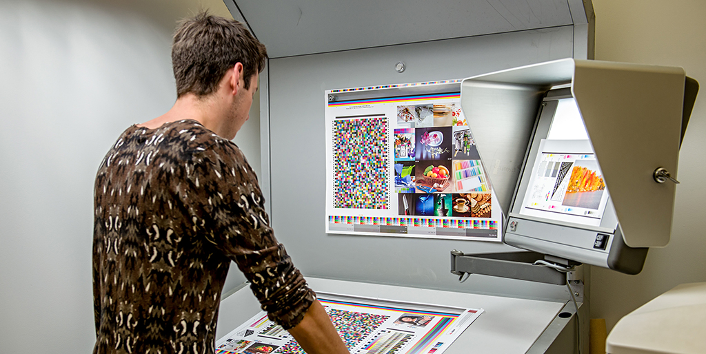 Student at a colour booth viewing a printed proof